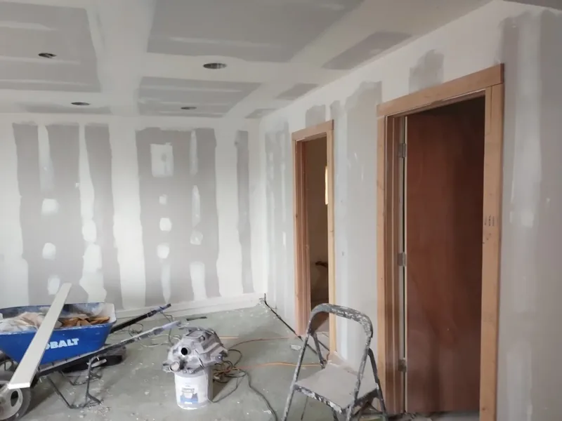 Drywall hung, taped, and mudded smooth, ready for paint
