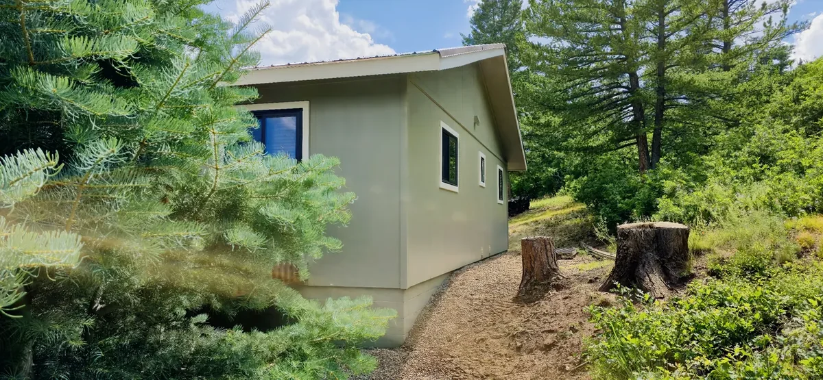 Freshly repainted mountain home exterior with clean siding, trim, and fascia