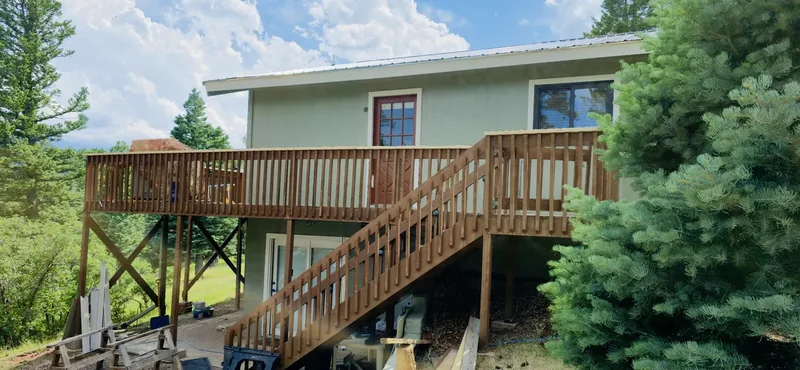 Home siding and trim freshly repainted in a warm tone
