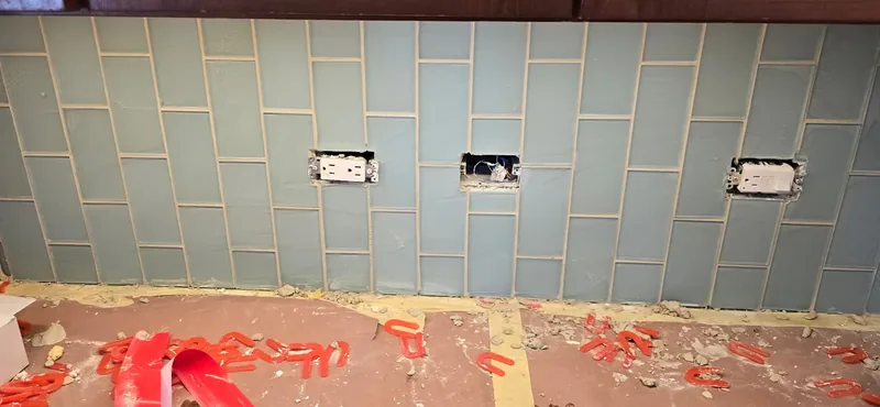 Subway tile backsplash in progress with outlet cutouts kept clean